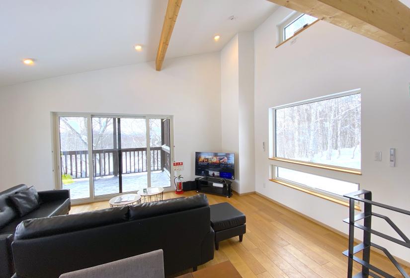 A living room with high ceilings and exposed beams