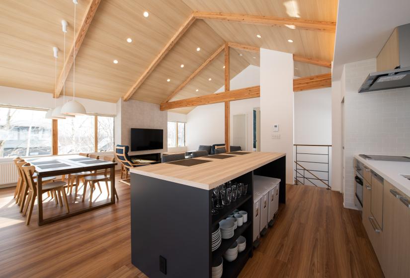 An island kitchen and dining table behind