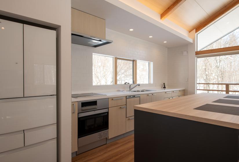 Hikaru kitchen with fridge, oven and ling bench top.   