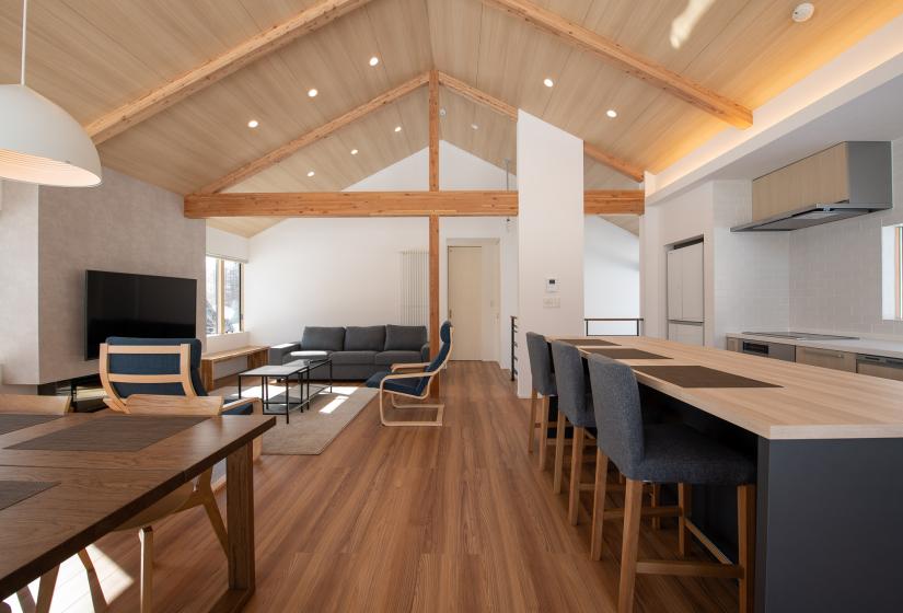 Dining table and island bench with lounge in back ground