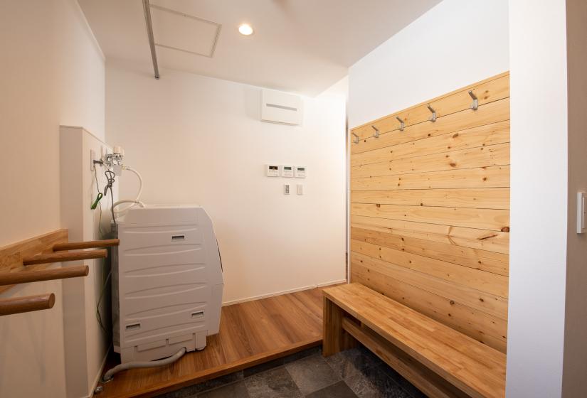 Laundry and ski storage area with timber wall to the right.