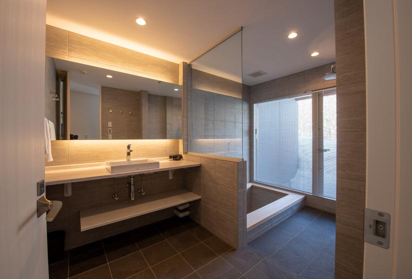 A modern bathroom with basin vanity and sunken bath tub