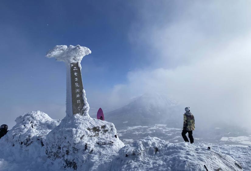 The views from the summit are spectacular even when there is a little cloud. A snow crusted monument at the top of Mount Annupuri with Mount Yotei in the back ground.
