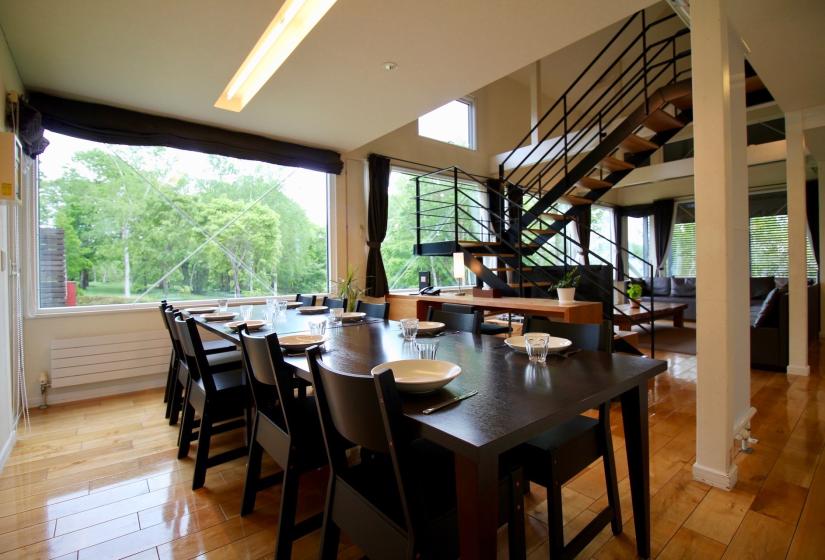 A black set dining table with white plates.