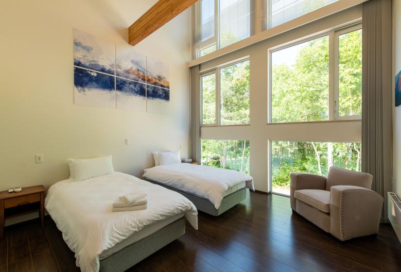 Master bedroom with  two single beds and an arm chair