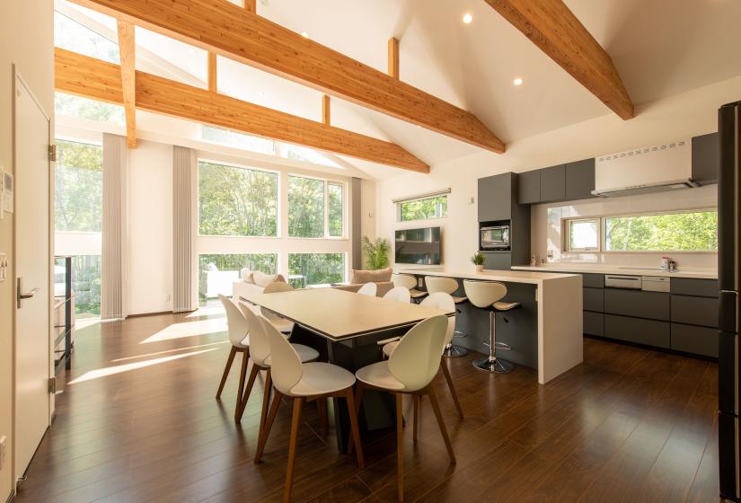 A white dining table in a spacious room