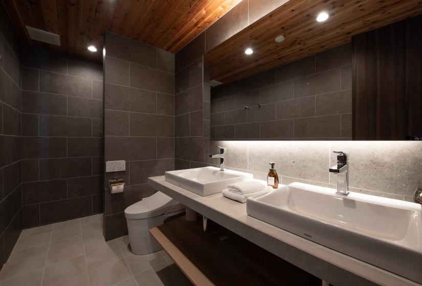 Two white basins with mirror behind