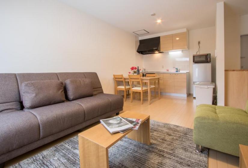 Cheap and cheerful, lodge Mori is modern, comfortable and budget friendly An open plan kitchen and lounge with black and green furniture