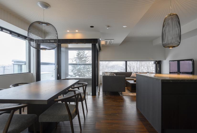 A dining table and mesh light shade above bench to right