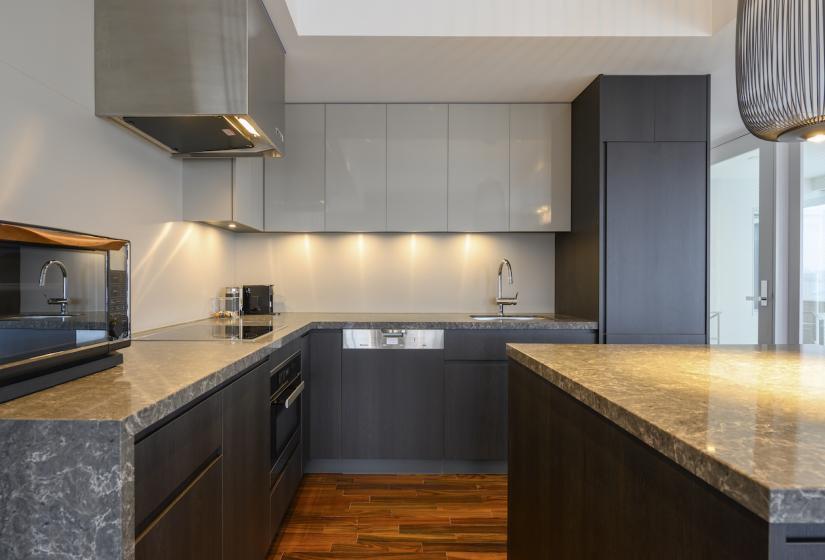 A kitchen with grey marble counter tops