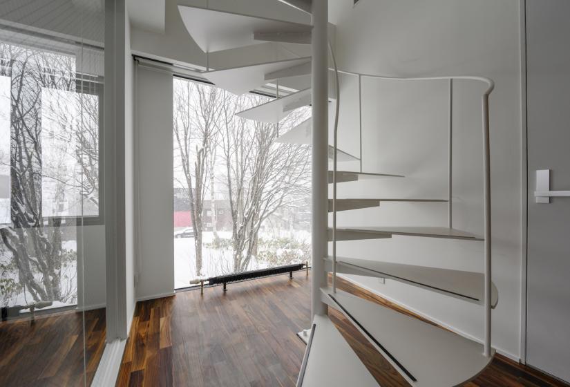 The base of a white spiral staircase