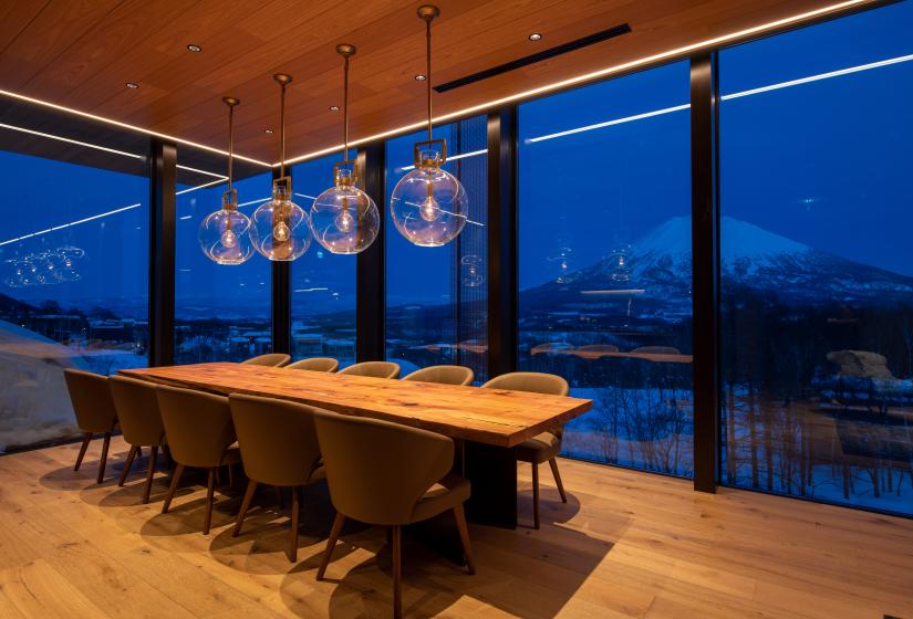 An evening view of Mount Yotei across a dining table