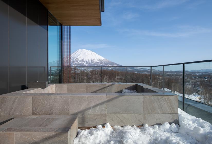 A balcony with snow and mountain view