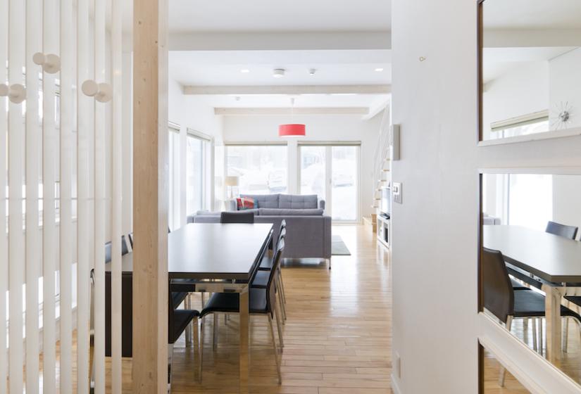 A long view of dining table and lounge behind