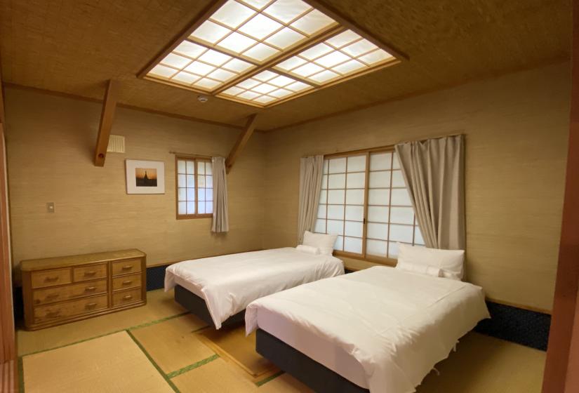 Two made up single beds on tatami mats