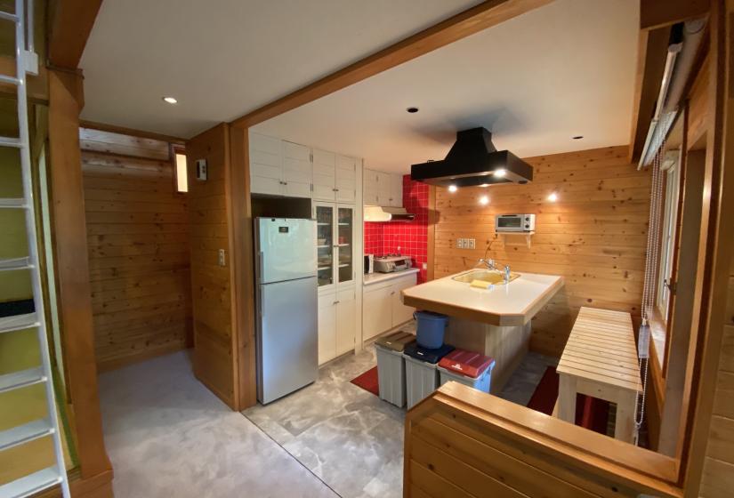 Kitchen with bench in middle of room