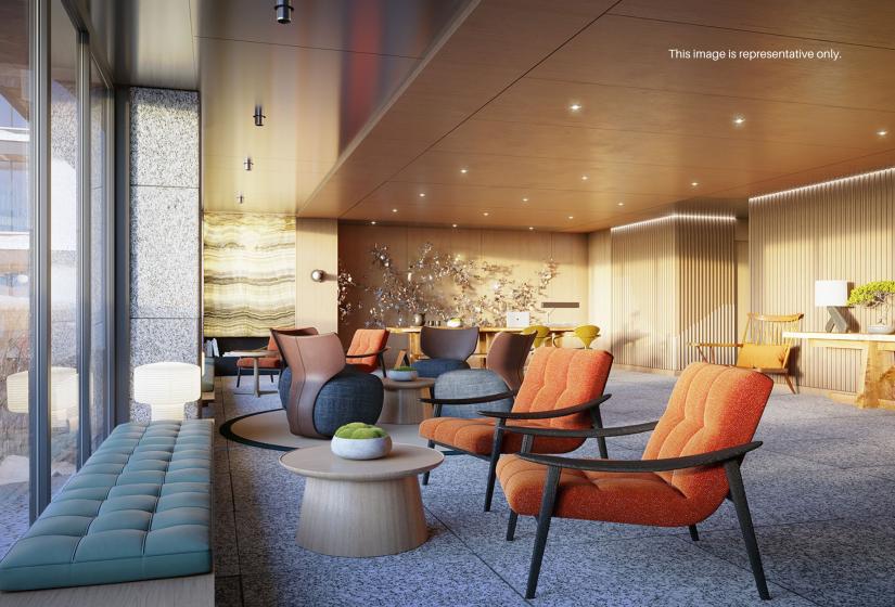 A computer generated image of a reception lobby area with orange chairs.