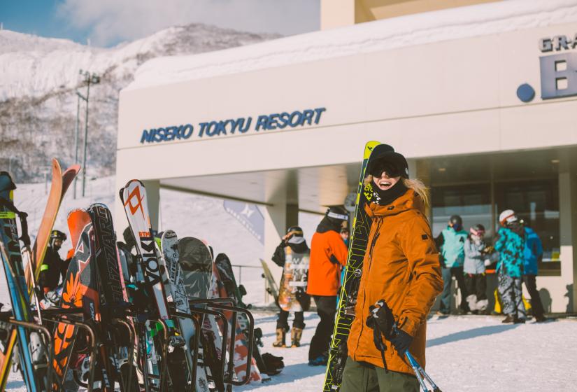 Book your guest services at your leisure and get thee most from your Holiday In Niseko A skier stands outside Hirafu's