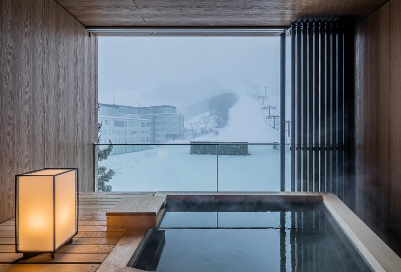Outdoor onsen with view over ski field