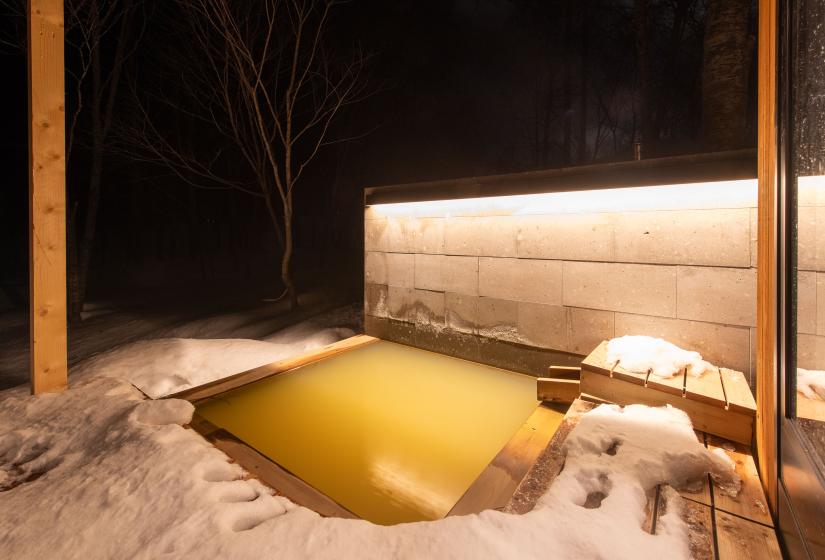 An outdoor onsen at night