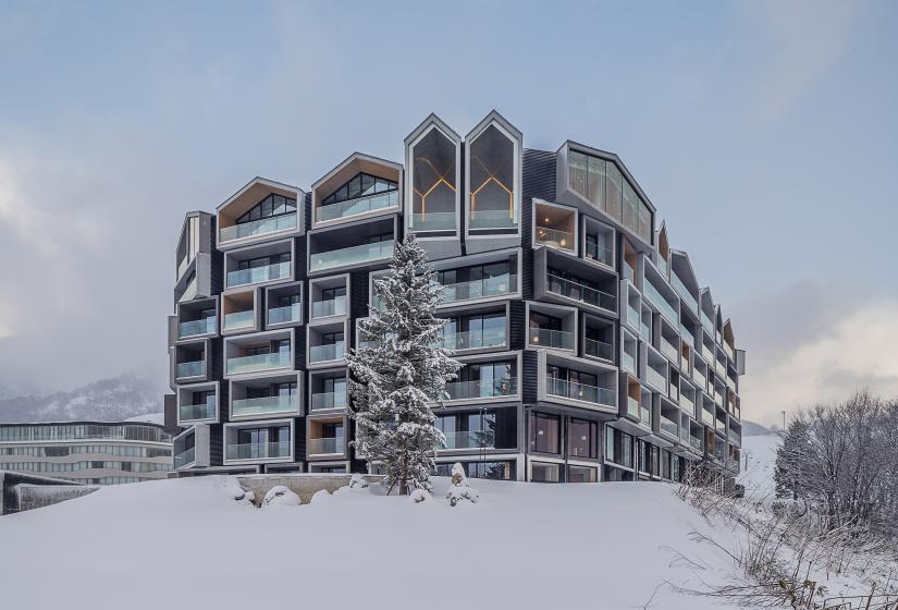 The exterior of a 6 story hotel in the snow