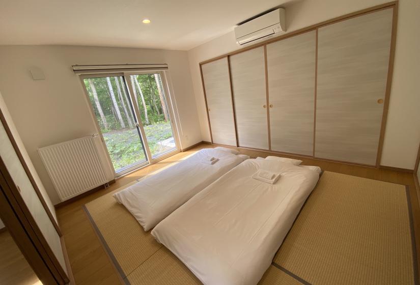 Two sets of futon bedding in a tatami room