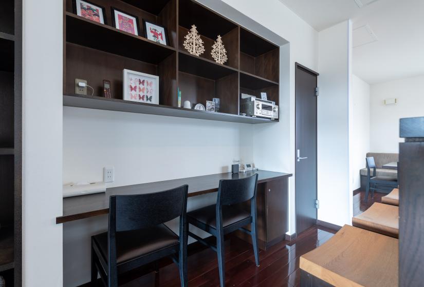 two seats at a counter with cabinet above