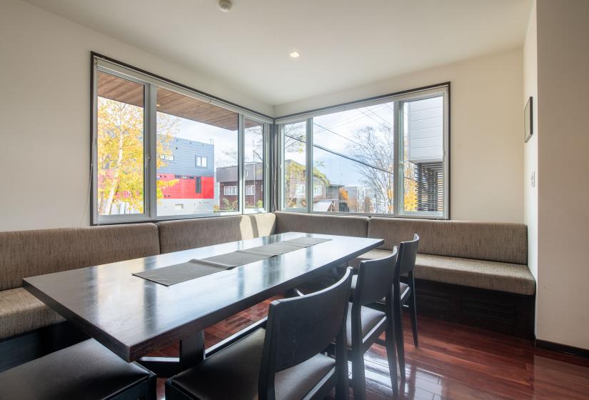 A dining table and windows behind