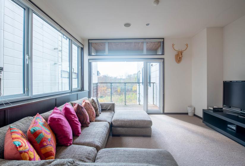 A long lounge suite with bright cushions