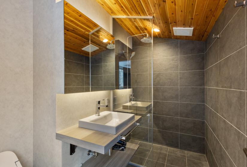 A tiled shower and sink