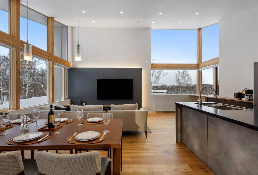 Dining table and kitchen bench with TV behind
