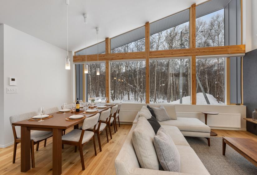 A dining table and grey couch