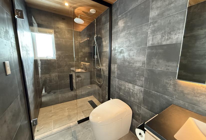 A tiled shower and toilet