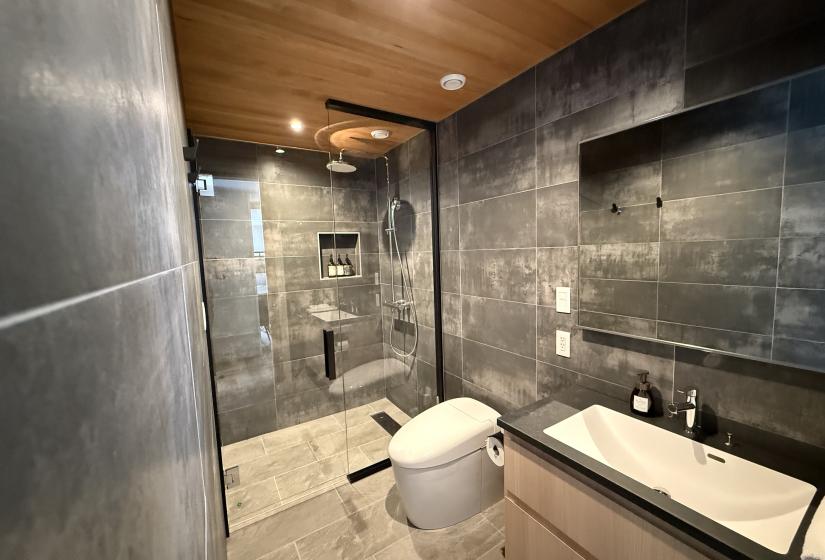 A tiled shower and sink
