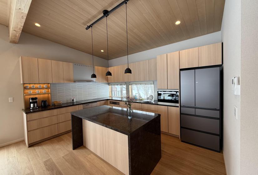 A kitchen with island and pendant lights