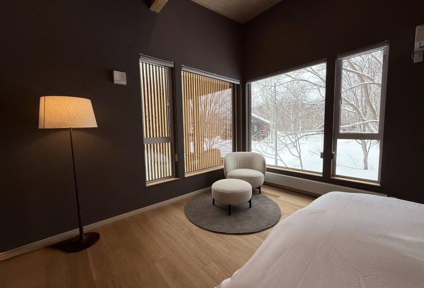 A lamp, chair and window behind