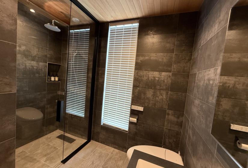 A tiled bathroom with white toilet