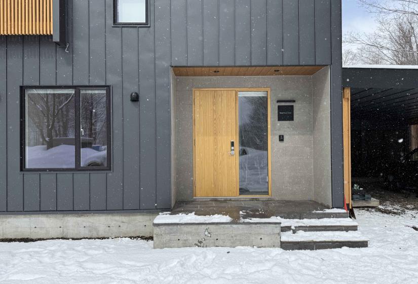 A front door and window to the left