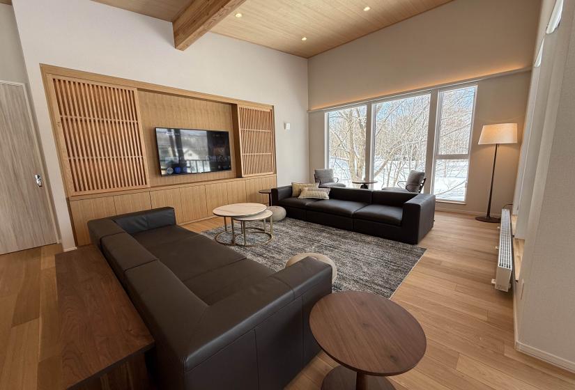 Two black lounge suites in a living room