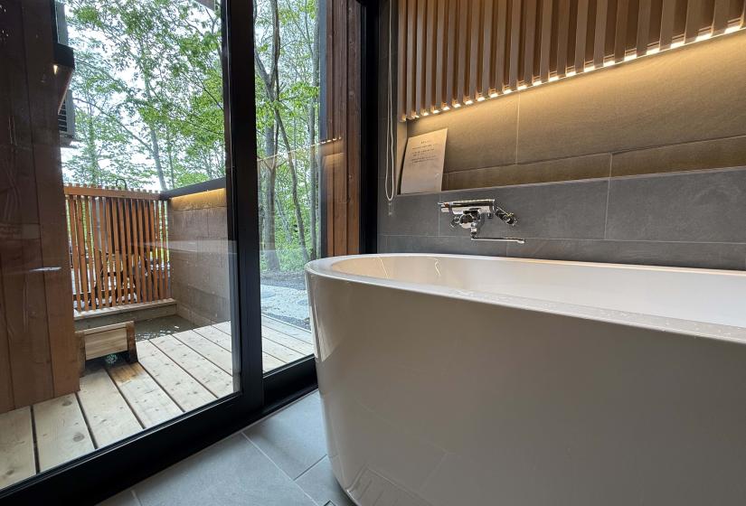 A white bath and led strip light above