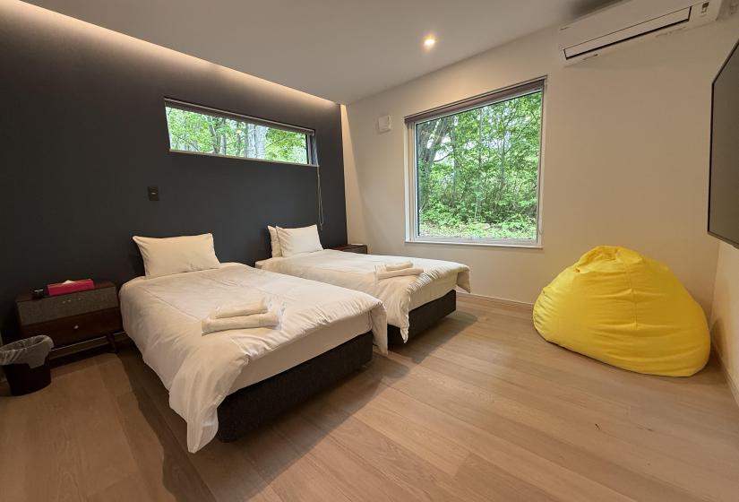 Two single beds with pillows and towels