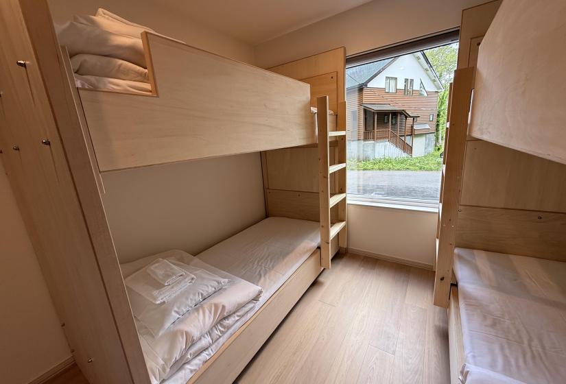 2 bunk beds and window behind
