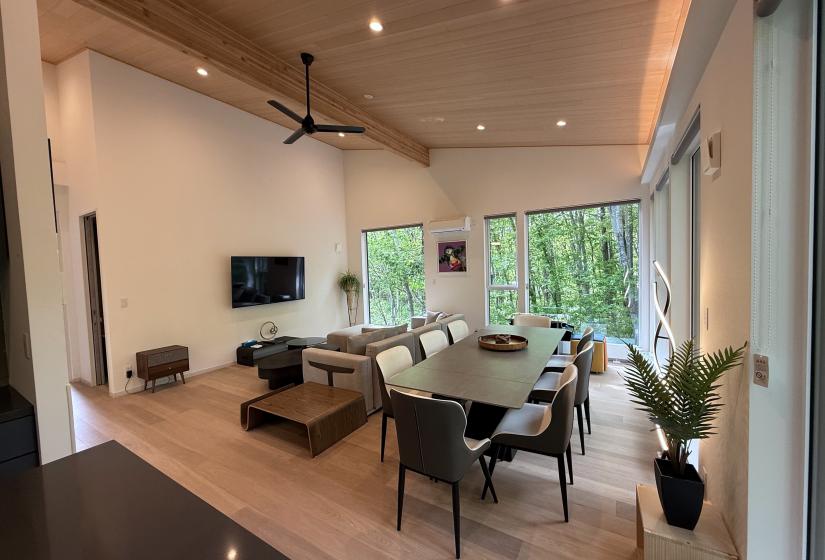A dining table and TV behind