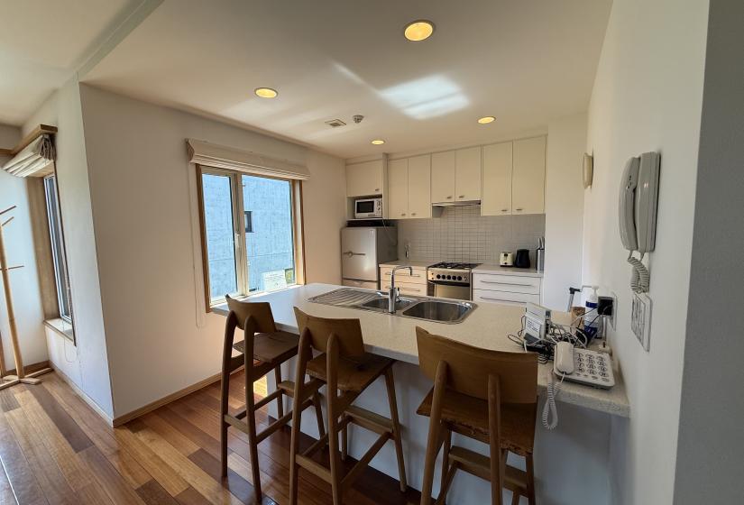 A breakfast bar and kitchen behind