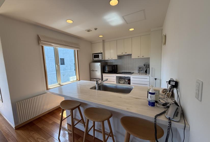 A kitchen bench and kitchen behind