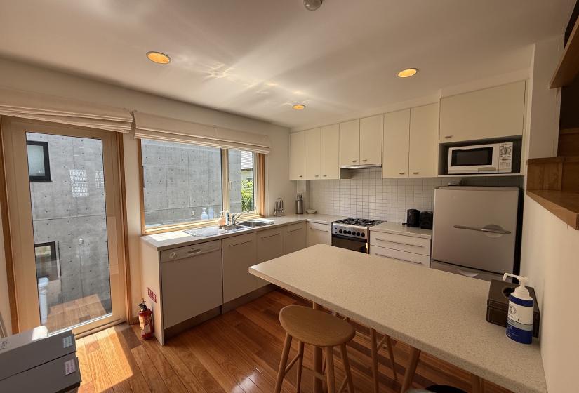 An island bench and kitchen behind