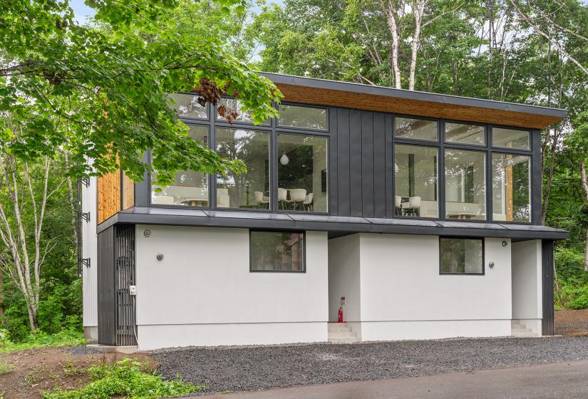 The exterior of a two story townhouse with large windows