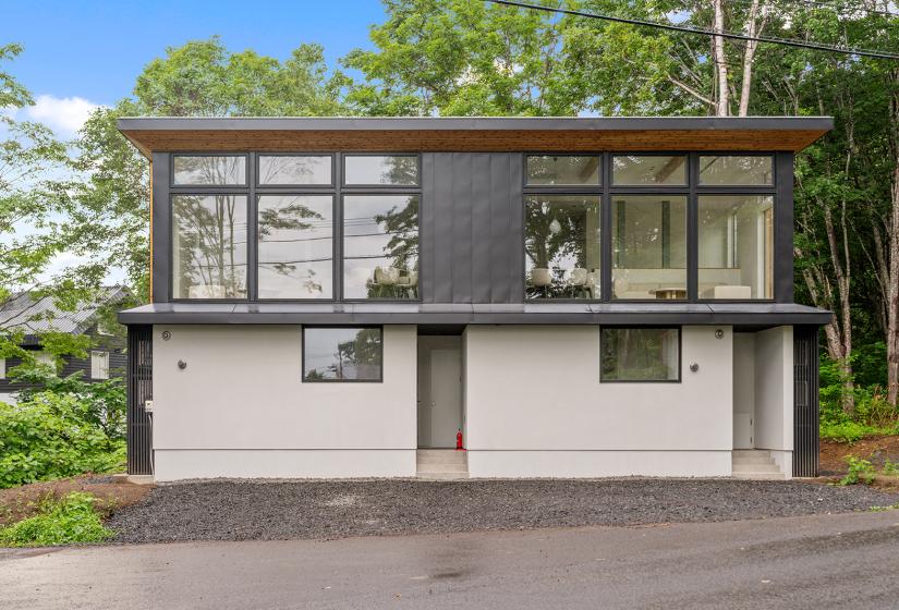 The exterior of a two story townhouse with large windows