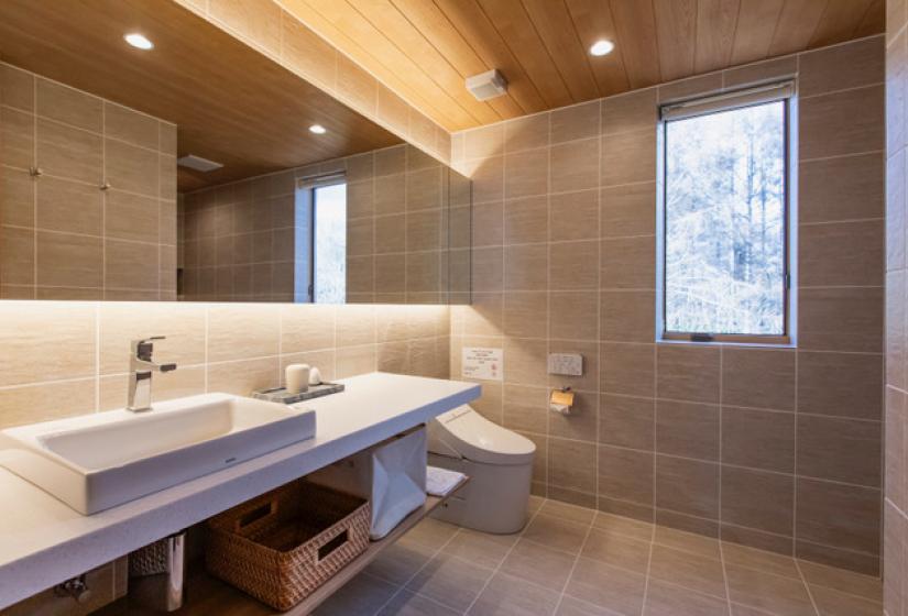 A bathroom sink with mirror behind