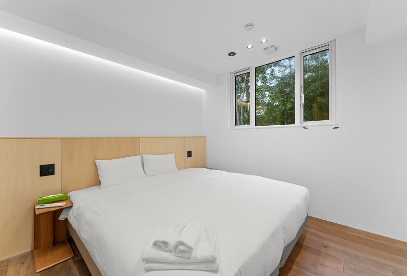 A white made up double bed